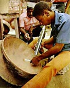 A Trinidadian panmaker tunes up a new pan